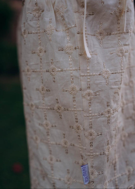 Close-up of a beige embroidered garment with a blurred background